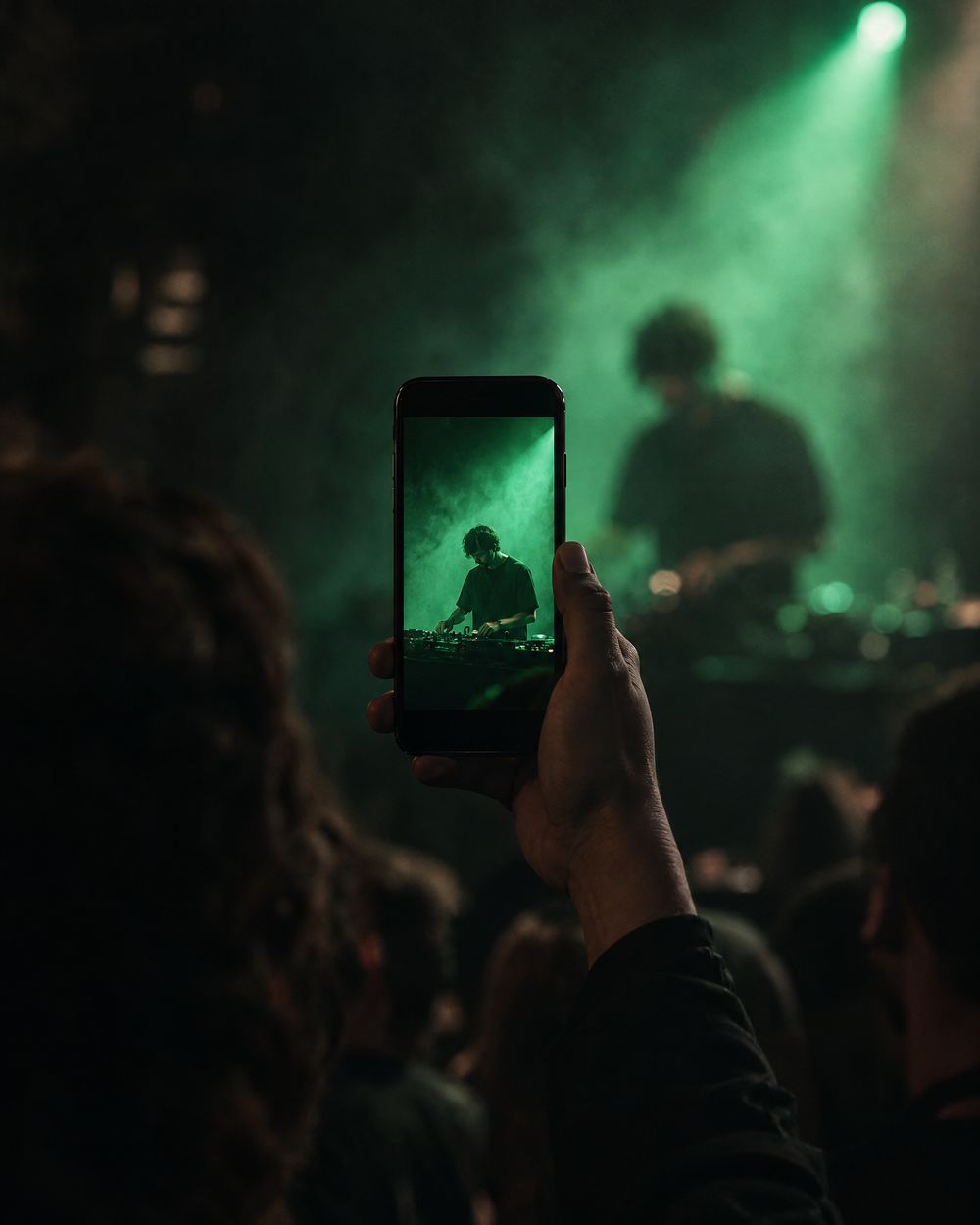A phone filming the DJ vertically